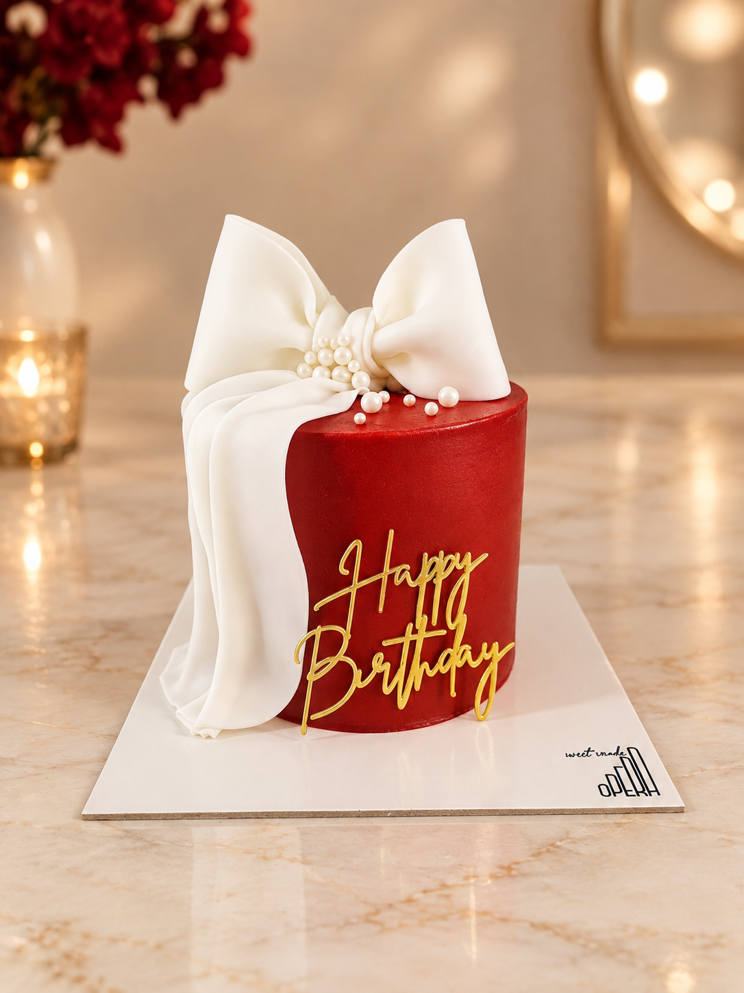 Red birthday cake with big white bow